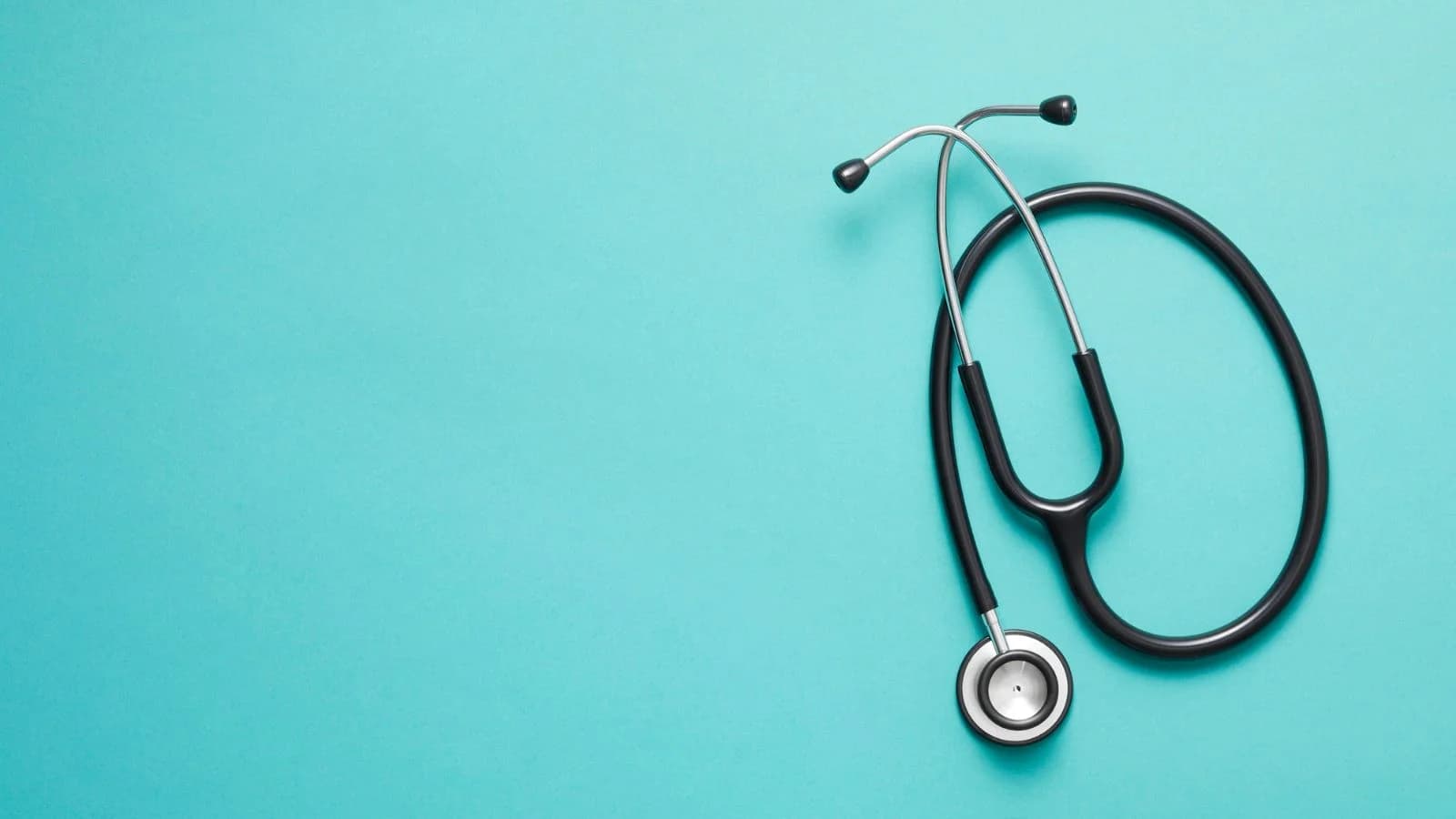 A physician's stethoscope on a teal background